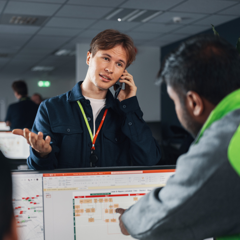 Foto av en Posten ansatt som er i telefonen